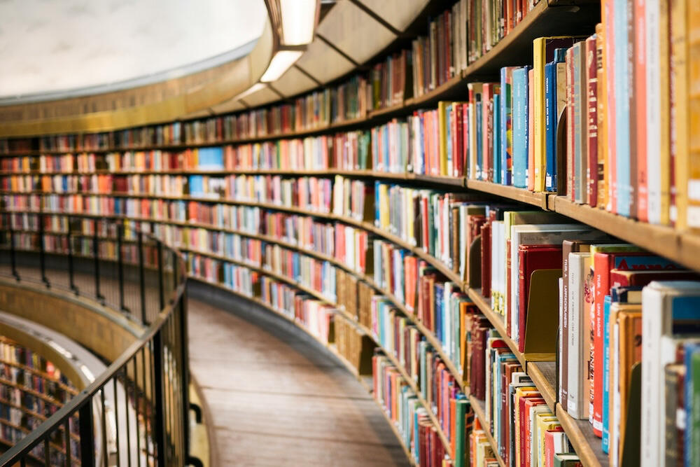Walkway in library with stacks of books