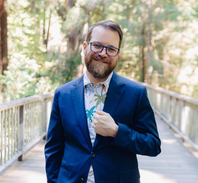Jason standing in front of trees